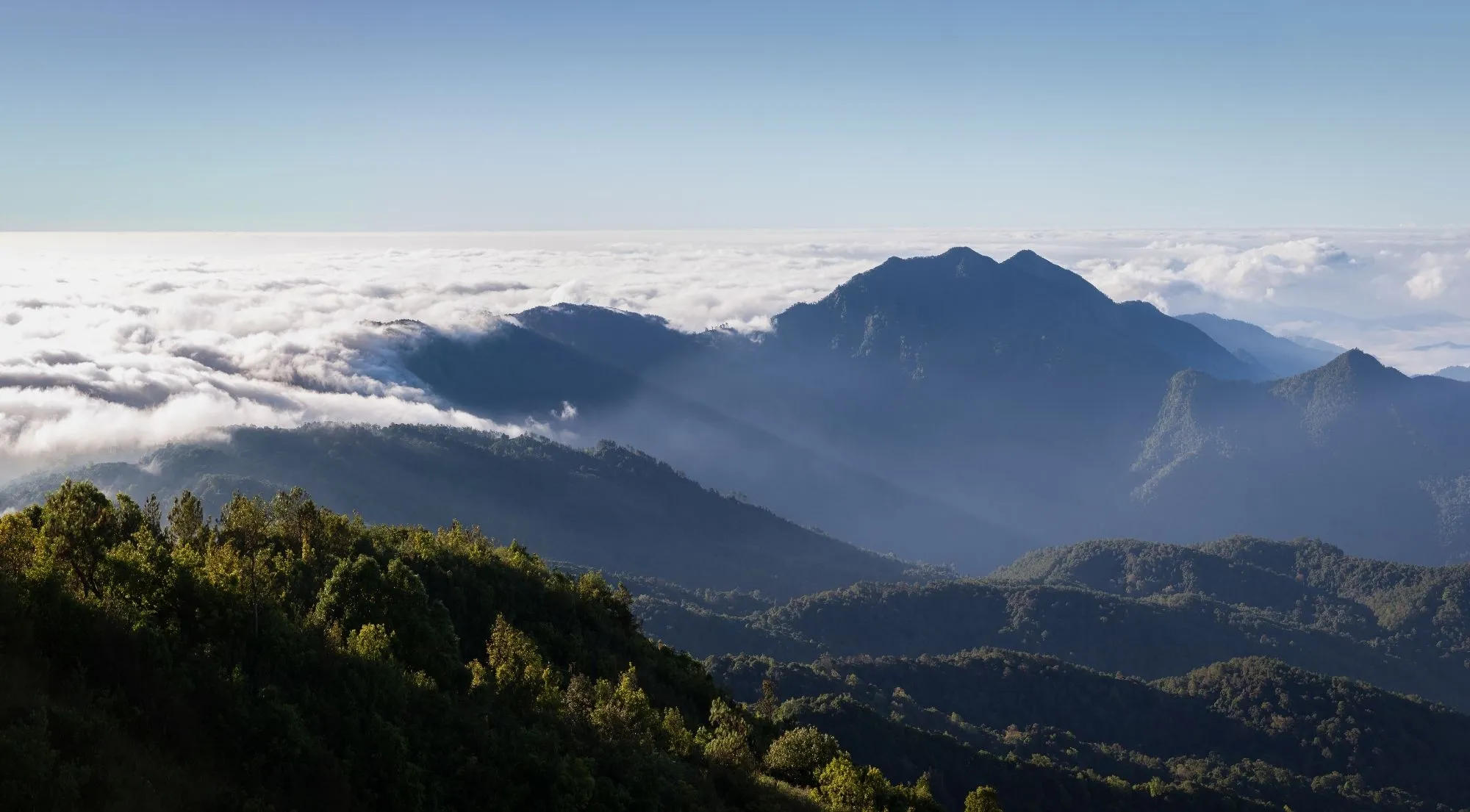 Clouds gathered between mountain ridges