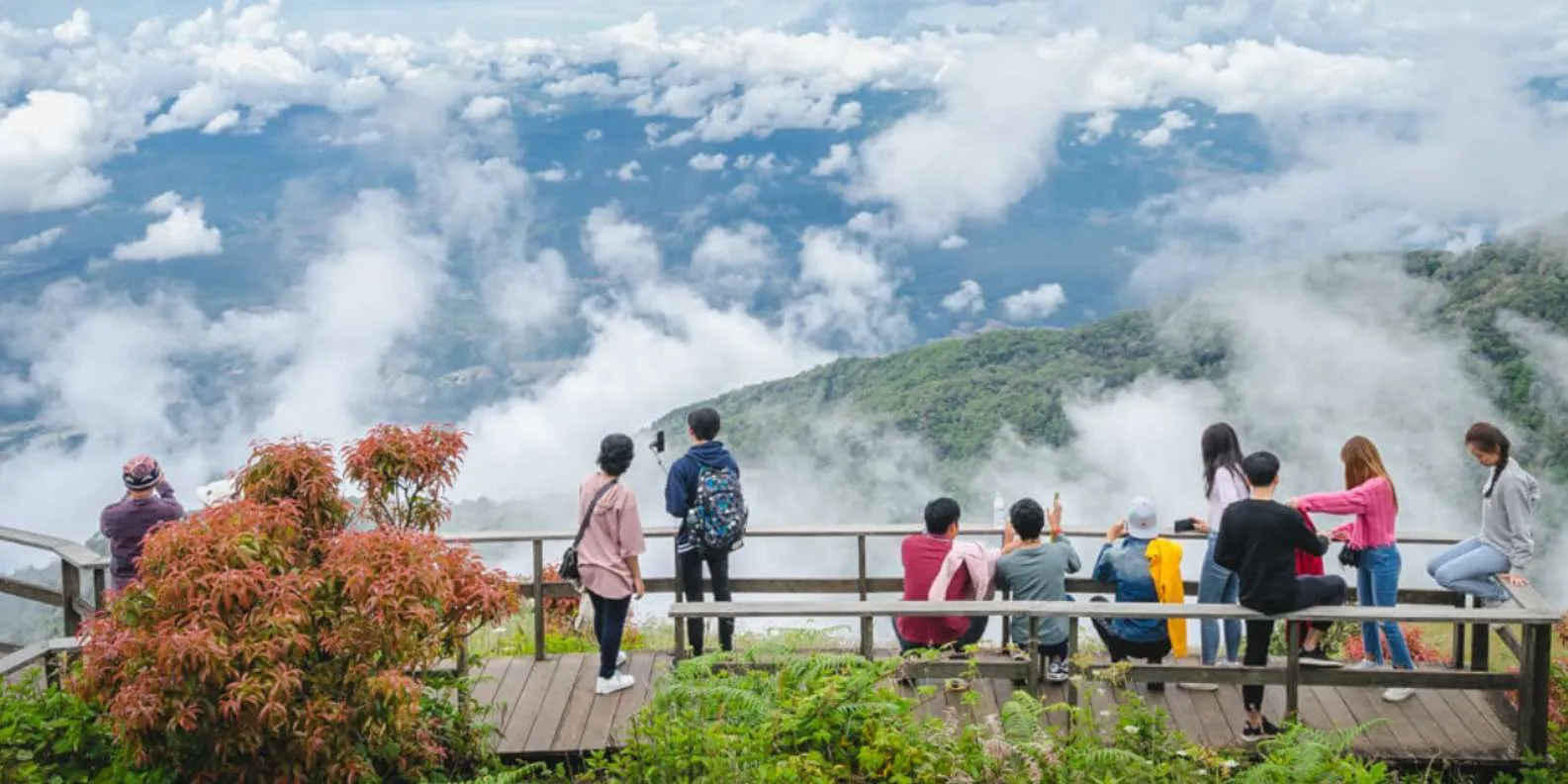 Visitors at a cloudy mountain viewpoint