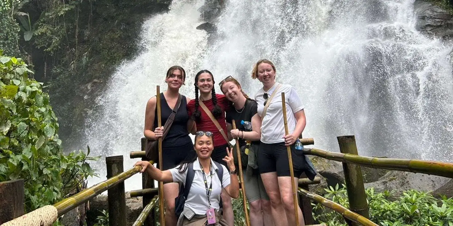 Group at a forest waterfall
